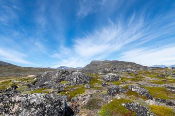 Greenland Nanortalik arctic lava stones volcanic mountain landscape on a sunny day with feather clouds