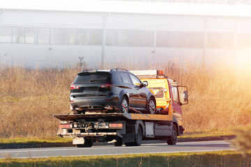 Tow truck helping car after highway breakdown
