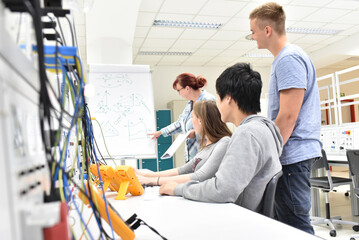 Group of young people in technical vocational training with teacher
