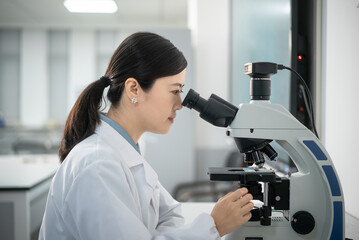 doctor using microscope in lab