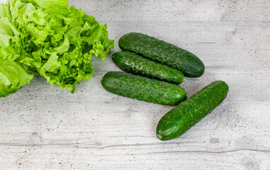 cucumbers and lettuce on the kitchen table