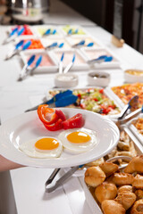 Buffet. Salad bar. Place food on a plate.