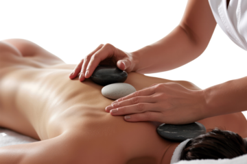 Relaxing hot stone massage therapy session with smooth stones applied on a person's back to relieve stress and tension in a serene setting.