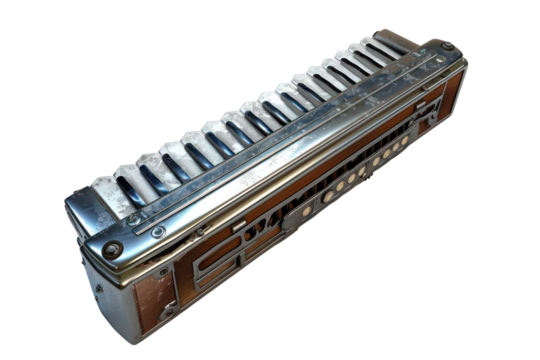Vintage chrome harmonica with intricate detailing, showcasing classic musical craftsmanship, isolated on white background.