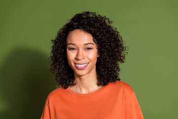 Photo portrait of pretty young girl look camera cheerful wear trendy orange outfit isolated on khaki color background