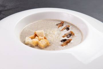 Cream of mushroom soup. On a dark background.