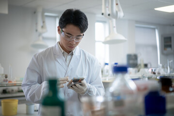 doctor using mobile phone in lab