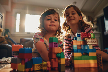 Kids constructing with toy bricks, showcasing teamwork and imaginative play, perfect for promoting educational toys and creative development