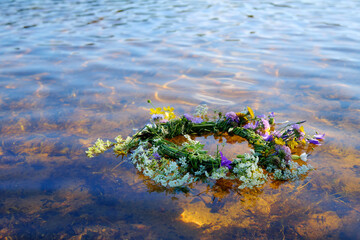 Flower Wreath on Water River. Ligo, Ivan Kupala. Midsummer Solstice Holiday concept