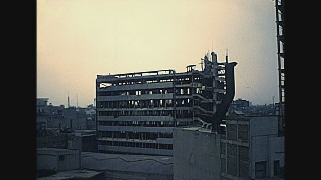 MEXICO CITY, MEXICO - circa 1970: Construction site of a new house with Mexican workers on top of the building. Archival of Mexico in South America in the 1970s.
