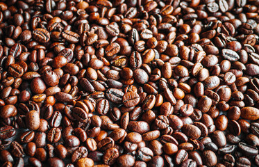 Top view of backdrop dark brown coffee beans and Textured background of freshly roasted coffee beans