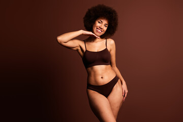 Obraz premium Photo of shiny sweet lady underwear lingerie enjoying body positive emtpy space isolated brown color background
