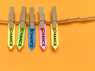Take your chances concept with multicolored paper background. Stock photo.