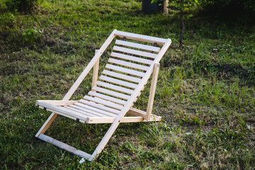 The wooden deck chair brings tranquility to the scenic meadow, seamlessly merging with nature for a...