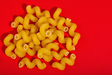 Pasta. Various kinds of uncooked pasta and noodles over wooden background
