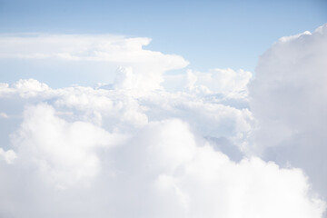 Sunrise above textured clouds from airplane window