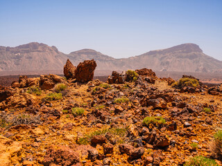 spot in Tenerife with many red rocks and beautiful mountain landscape background