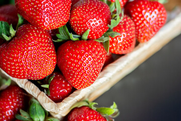 ripe juicy strawberries, harvest in a basket on the table. High quality photo