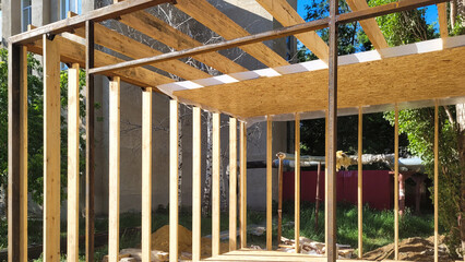 Construction of a street shopping pavilion for a store, all stages of construction detailed overview. The third stage - installation of wooden boards around perimeter and on the roof