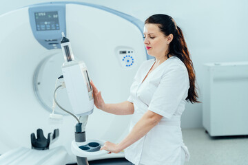 Technician standing in front of MRI scanner