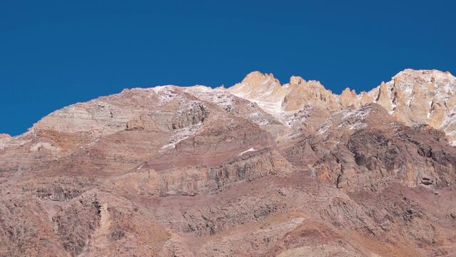Snowy Himalayan mountain range as seen from Chandra Taal Lake in Spiti Valley, Himachal Pradesh, India. Snow covered Himalayan mountain peaks as seen from the glacial Chandratal lake in Spiti at Noon.