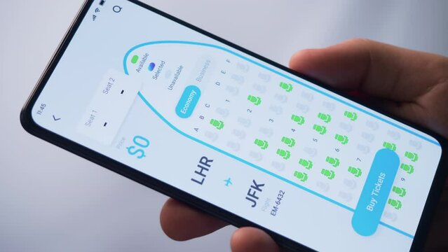 Buying plane tickets online. Choosing seats in a plane using booking app for mobile phone. Fictional Interface.
