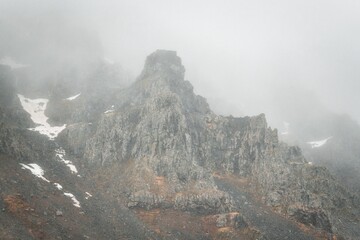 Fog and low clouds over mountain peaks create a mystical atmosphere in Iceland