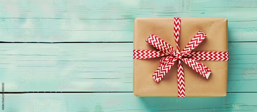 Poster Wrapped vintage gift box with red and white ribbon bow pastel background. with copy space image. Place for adding text or design