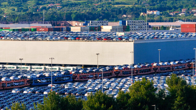 AERIAL Rows of countless cars sit parked in the parking lot of Luka Koper harbor
