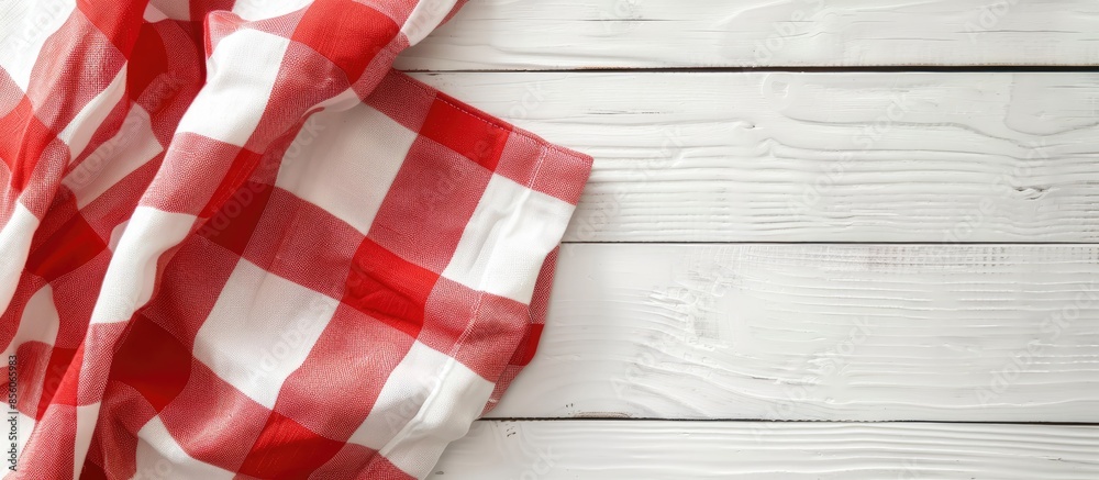 Poster the tablecloth checkered red and white fabric cotton folded place on a white table with copy space. 