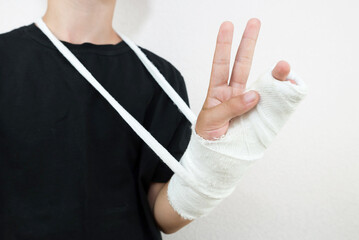 Teenager with a bandaged hand.