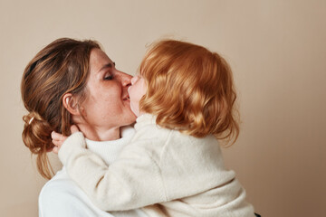 Tender moment mother kissing daughter in arms, love and family, bonding embrace, parenting connection, affectionate parentchild relationship