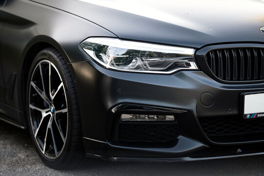 Minsk, Belarus. May 3. BMW M5 F90 Competition on parking lot. LED adaptive headlights and dynamic grille of Satin Black BMW M5 F90. Front body exterior closeup.