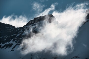 Fog and low clouds over mountain peaks create a mystical atmosphere in Iceland