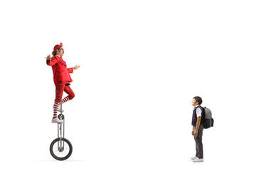 Schoolboy watching an acrobat riding a giraffe unicycle © Ljupco Smokovski