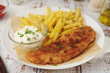 Fish and chips served on the plate, traditional dish of Great Britain	