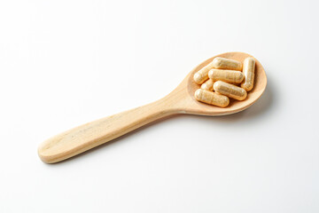 Herbal capsules in wooden spoon, Natural herbs, Alternative Medicine, Herbal supplement