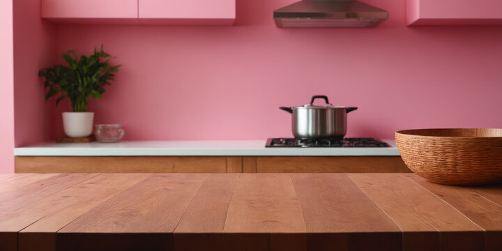 Empty natural wood kitchen table top for product display. Background with blurred modern pink kitchen mock-up for product montage, banner posters or presentations with copy space. Selective focus.