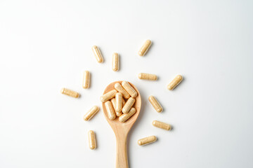 Herbal capsules in wooden spoon, Natural herbs, Alternative Medicine, Herbal supplement