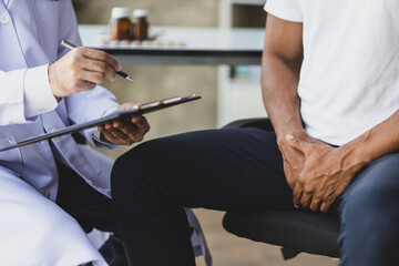 Specialist doctors are diagnosing male patients with symptoms of sexual dysfunction and providing...