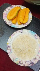 Sweet and delicious with mango and 
white rice put on dark table
