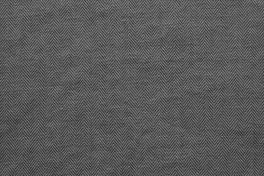 A close-up image of a gray herringbone fabric texture.