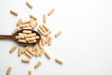 Herbal capsules in wooden spoon, Natural herbs, Alternative Medicine, Herbal supplement
