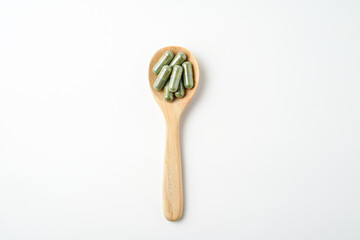 Herbal capsules in wooden spoon, Natural herbs, Alternative Medicine, Herbal supplement