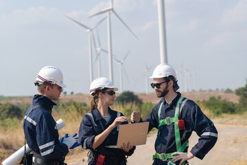 engineers working in fieldwork outdoor. Workers walking and inspect construction and machine around project site. Wind turbine electrical of clean resource enerdy and environment sustainable.