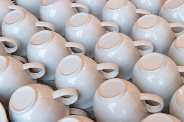 Close-up of many cups for coffee standing upside down ready to use.