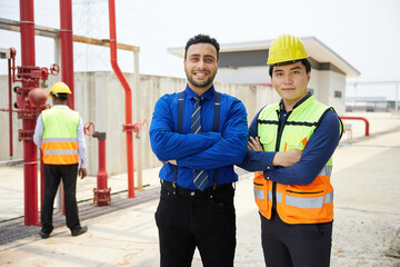 worker and businessman smiling and folded arms pose in the factory