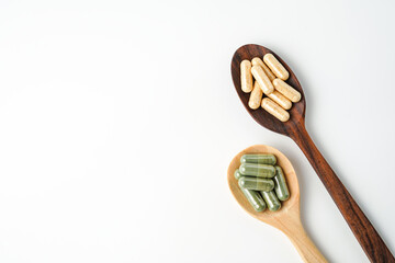 Herbal capsules in wooden spoon, Natural herbs, Alternative Medicine, Herbal supplement