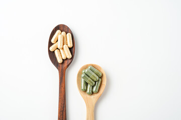 Herbal capsules in wooden spoon, Natural herbs, Alternative Medicine, Herbal supplement