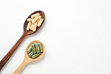 Herbal capsules in wooden spoon, Natural herbs, Alternative Medicine, Herbal supplement